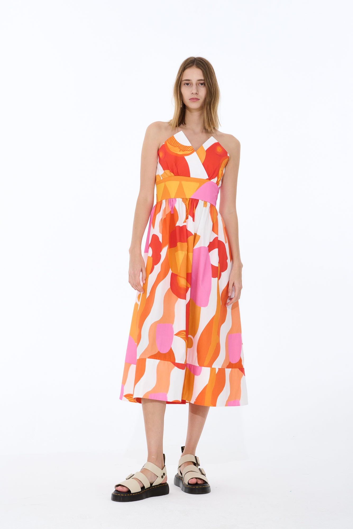 Charro Dress in Marea Roja: Cotton midi dress in vibrant orange, pink and white combo print, featuring a flattering silhouette and a comfortable fit. Perfect for spring and summer outings. Made by De Loreta.