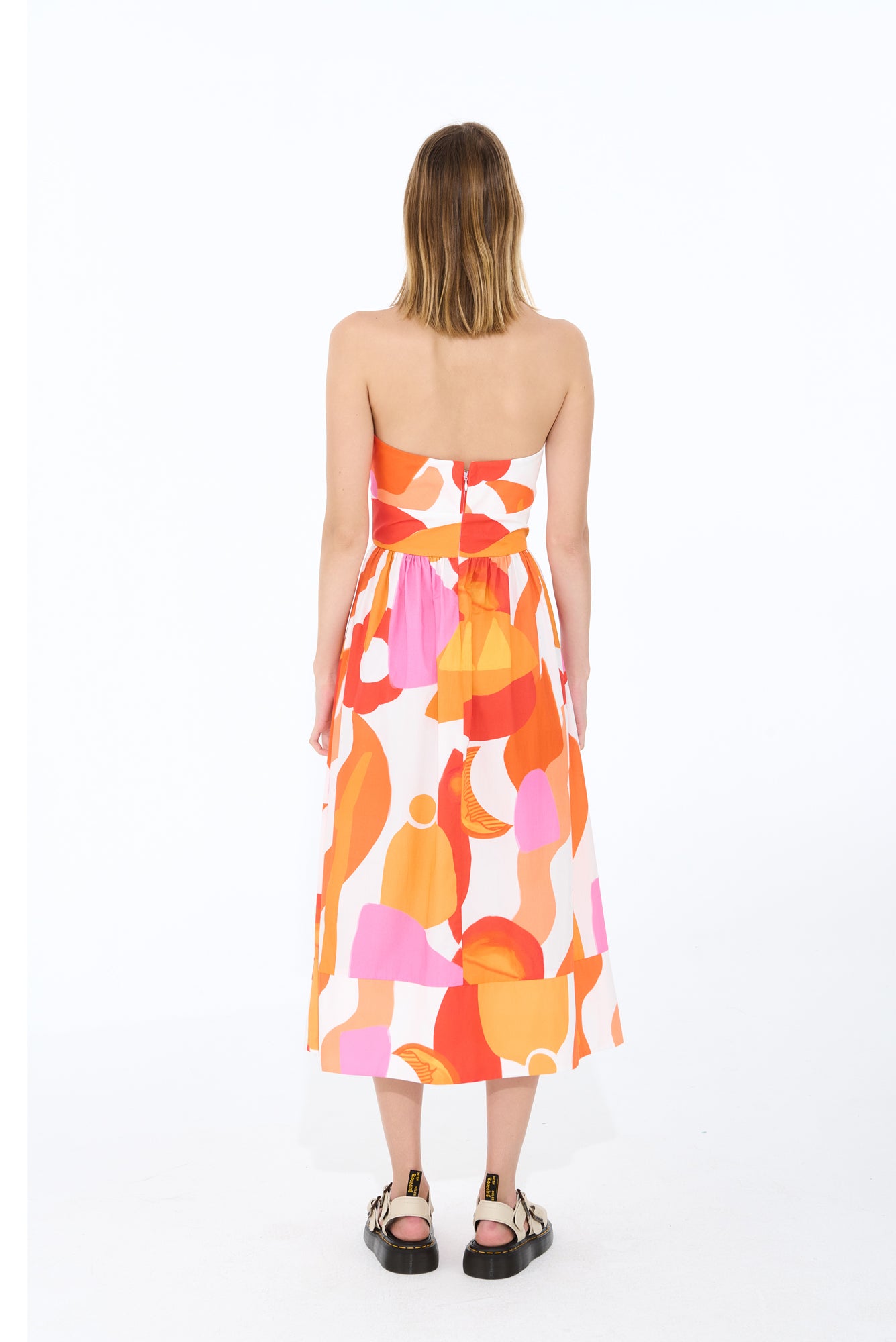 Charro Dress in Marea Roja: Cotton midi dress in vibrant orange, pink and white combo print, featuring a flattering silhouette and a comfortable fit. Perfect for spring and summer outings. Made by De Loreta.