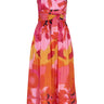 De Loreta Charro Dress in Anturio print: Cotton midi dress in vibrant red, orange and pink floral artistic print, featuring a flattering silhouette and a comfortable fit. Perfect for fall and winter outings. Front view.