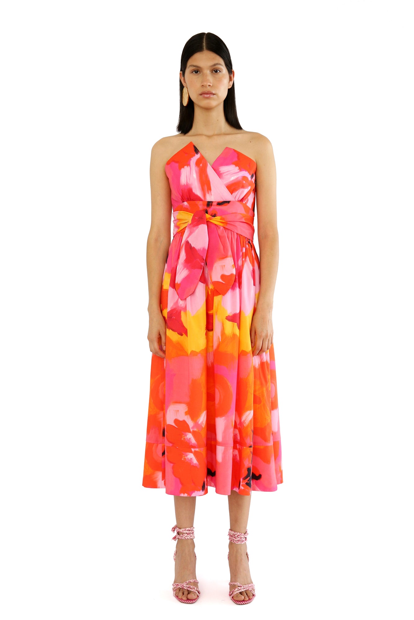 De Loreta Charro Dress in Anturio print: Cotton midi dress in vibrant red, orange and pink floral artistic print, featuring a flattering silhouette and a comfortable fit. Perfect for fall and winter outings.